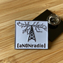 aNONradio Commemorative White Enamel Pin